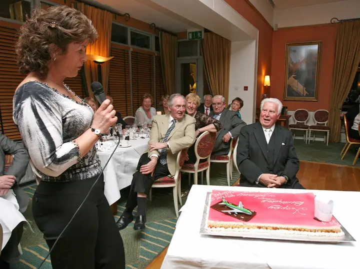 His daughter Jackie presenting the cake to him