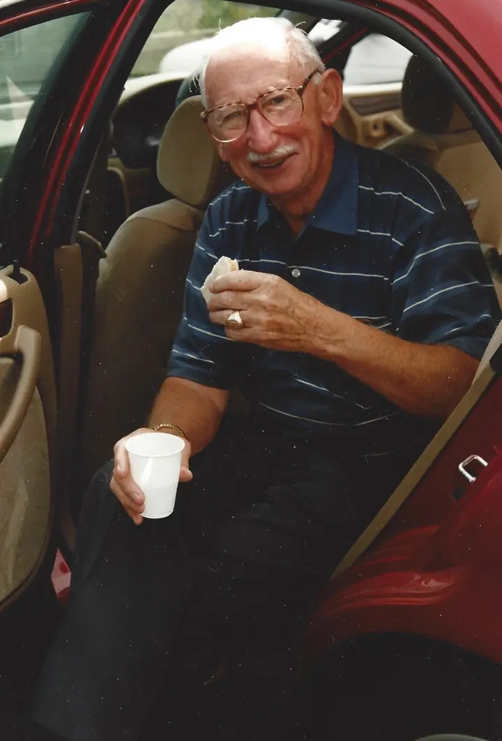 Joe having a snack in the back of the car